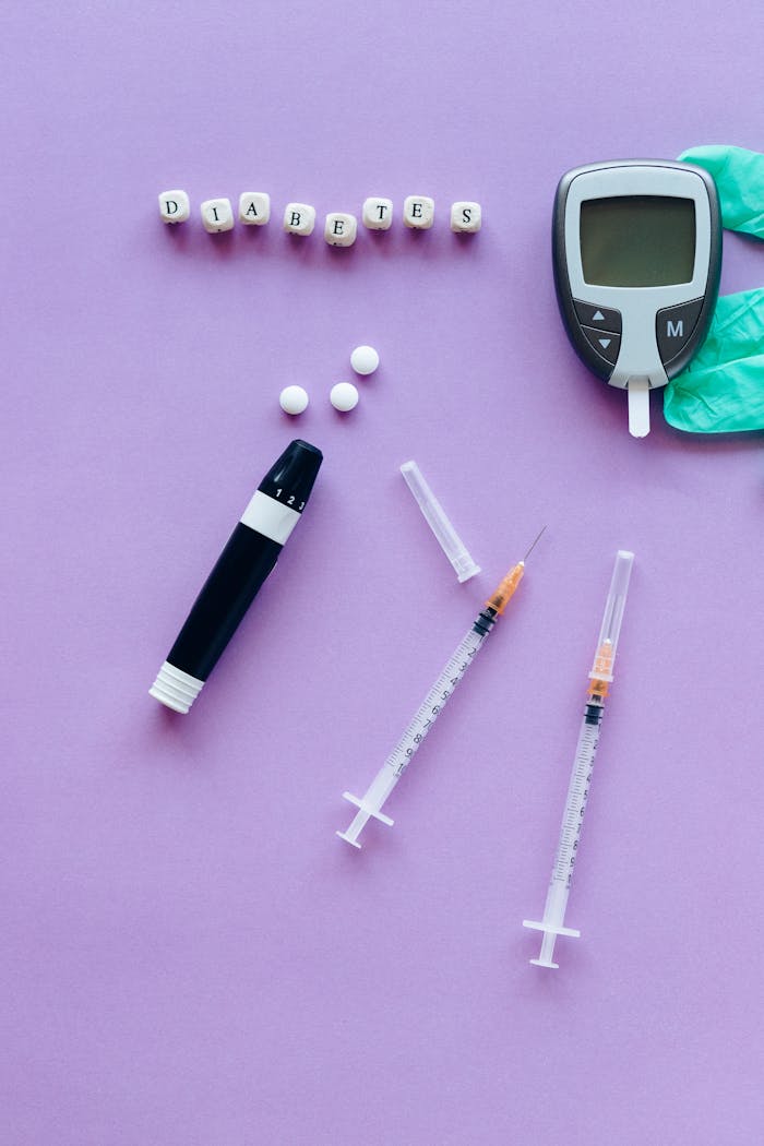 Medical supplies for diabetes management on a purple background.