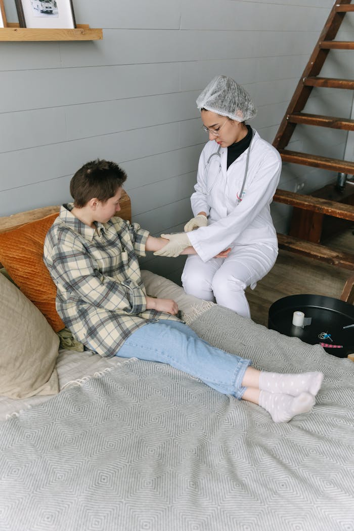 Healthcare worker assisting a patient in a home setting, providing care and support.